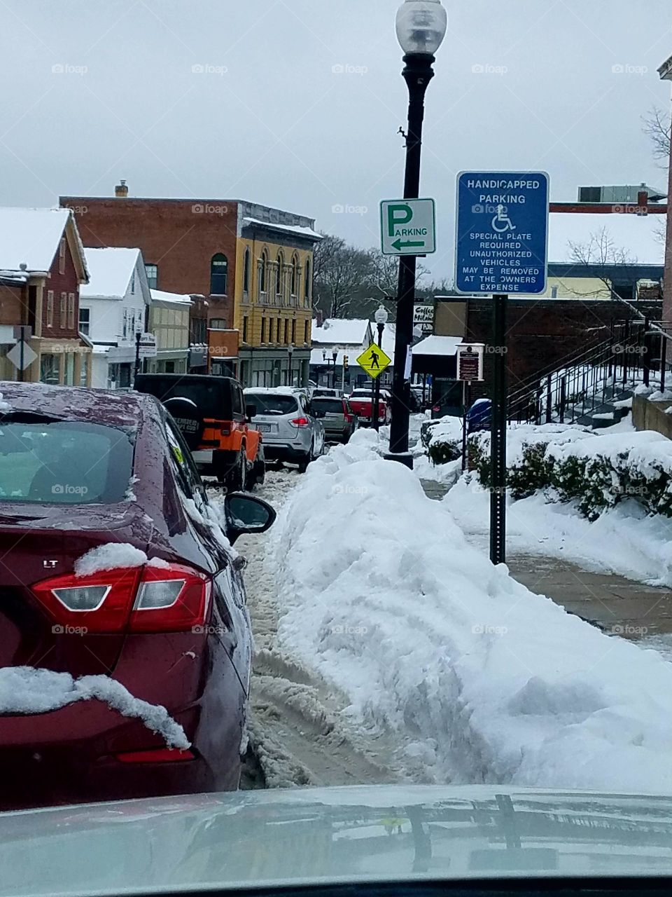 Snowstorm in Town, mound of snow to get to sidewalk. New England wintertime.