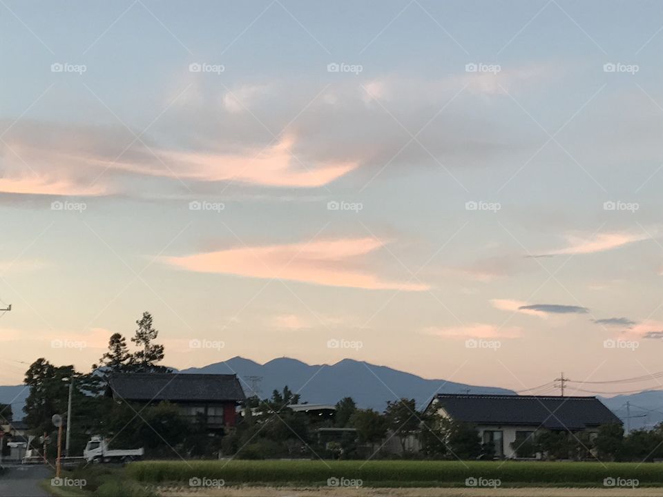 Japanese Houses at Sunset against Mountain