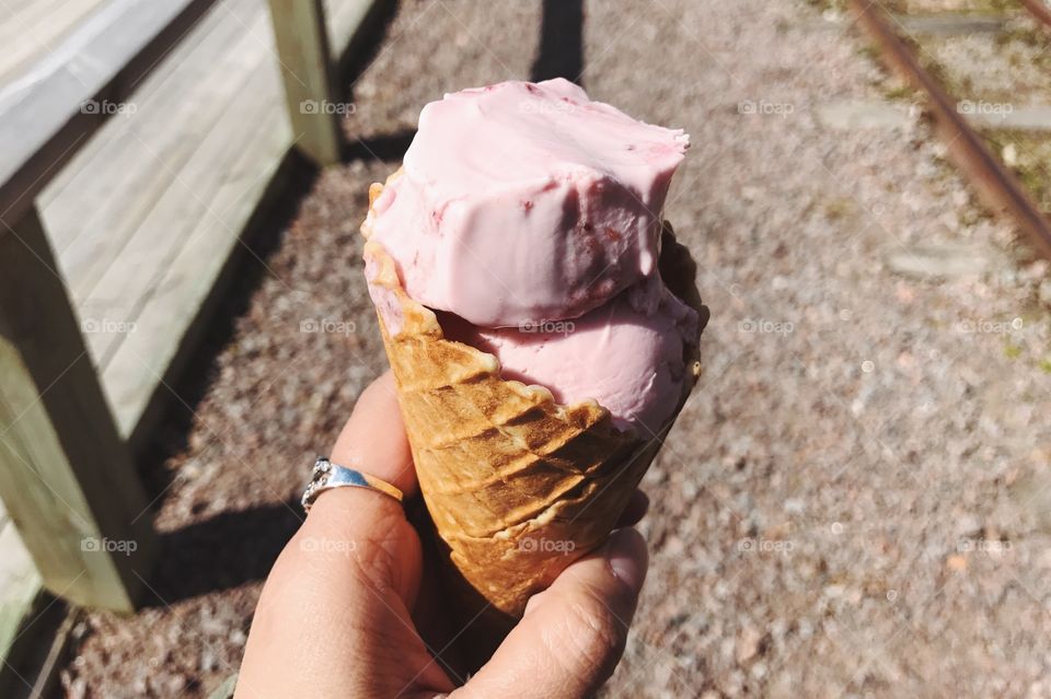 Ice cream cone in human hand