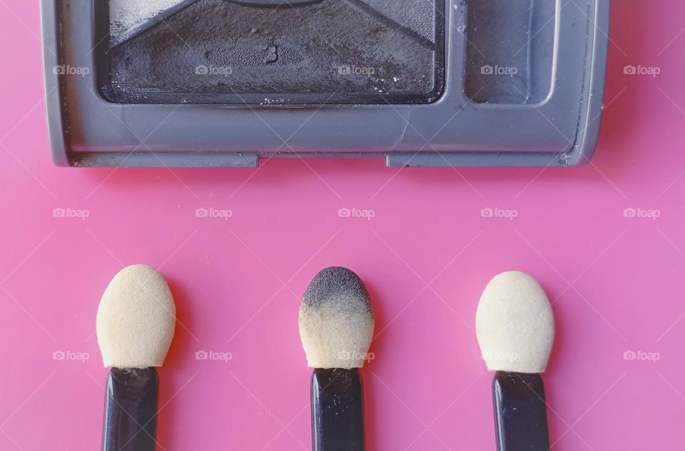 Used smokey eyeshadow and sticks in pink background...