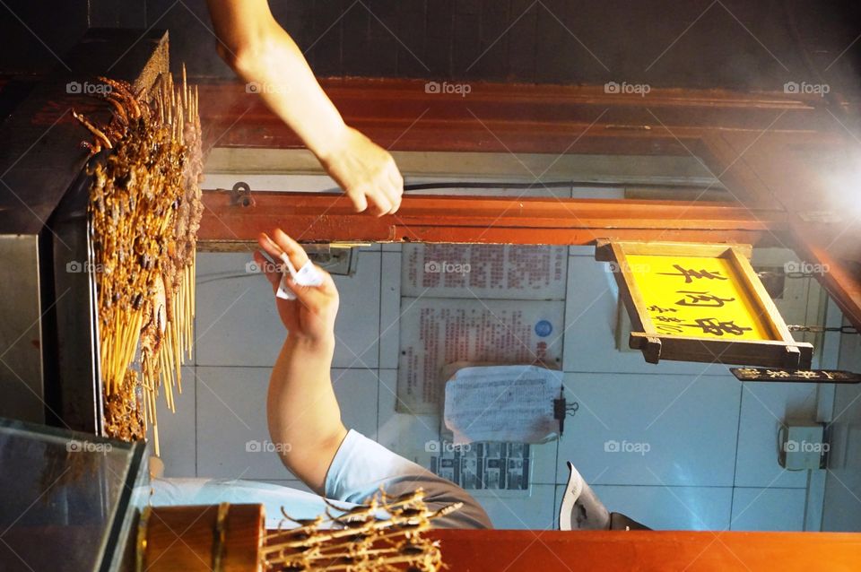 fair trade. a customer buying street food in Beijing