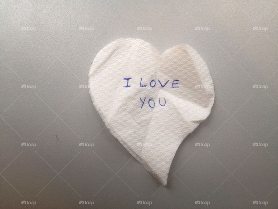 Heart shaped from napkin with love message
