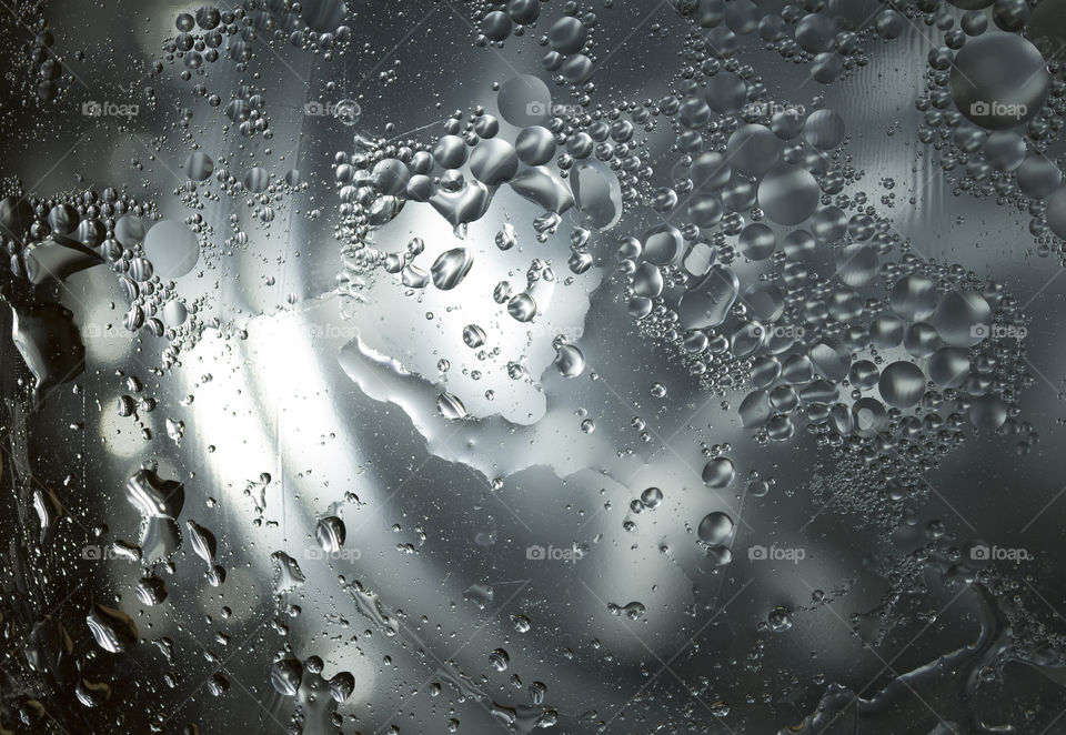 abstract background: glass transparent surface above stainless steel texture