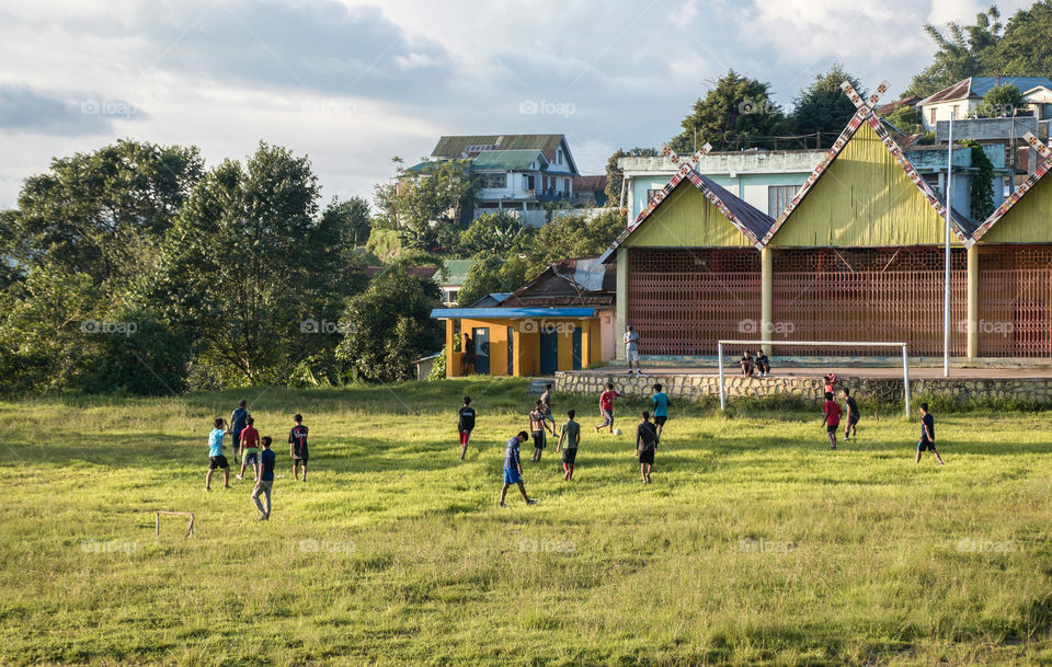 Even though the grass has grown tall, the youngsters are happy to be back in the field to enjoy their game