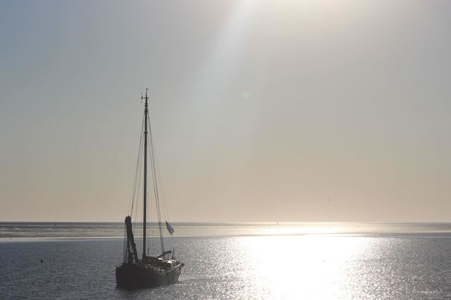 Fishing ship on the Waddensea. 
This fishing ship sails from The Northsea to the Waddensea between, left, Schiekmonnikoog and, right, the mainlands of The Netherlands. To reach his harbor before sunset.