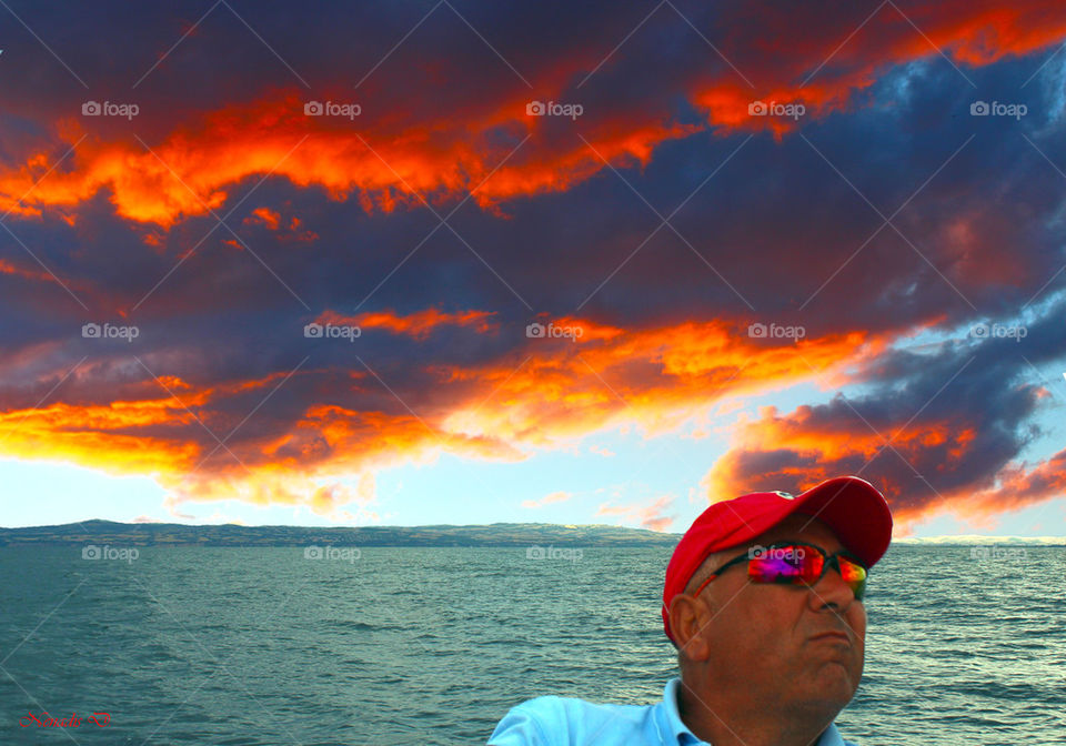 Close-up of a man against dramatic sky