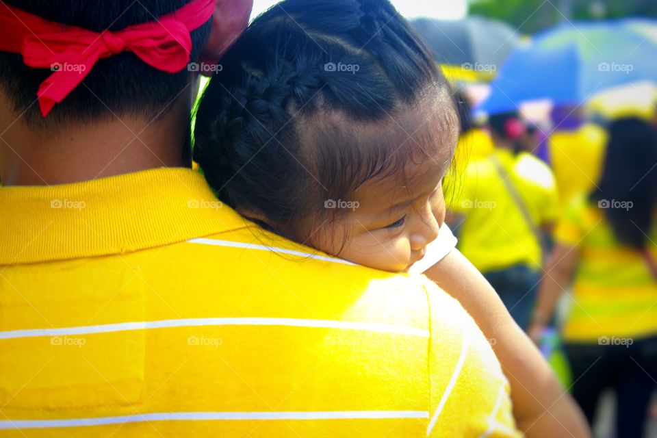 This man carries his baby in a procession called "Traslacion" in the city of smiles - Naga City, Philippines. 
