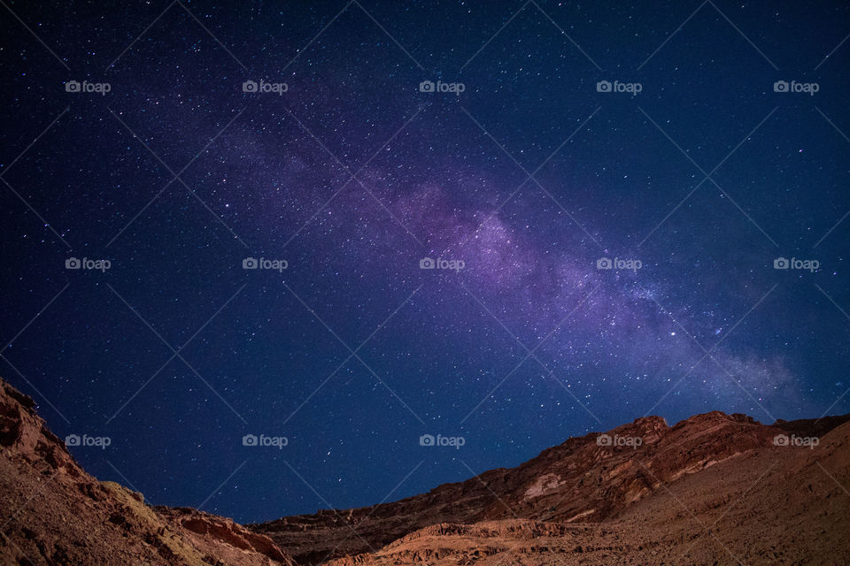 Milky way galaxy as seen from the desert at a dark night on long exposure