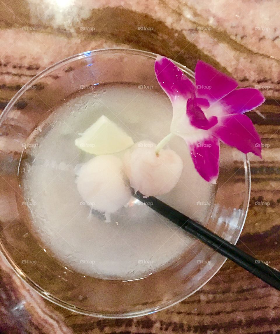 Lychee nut martini with edible orchid