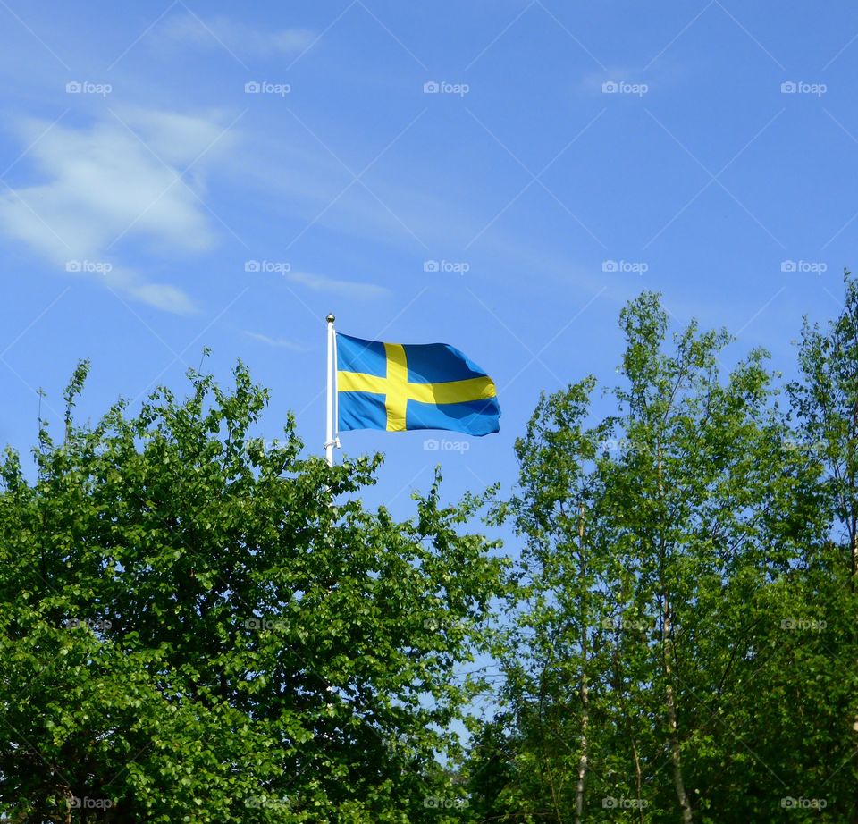 The swedish flag against blue sky