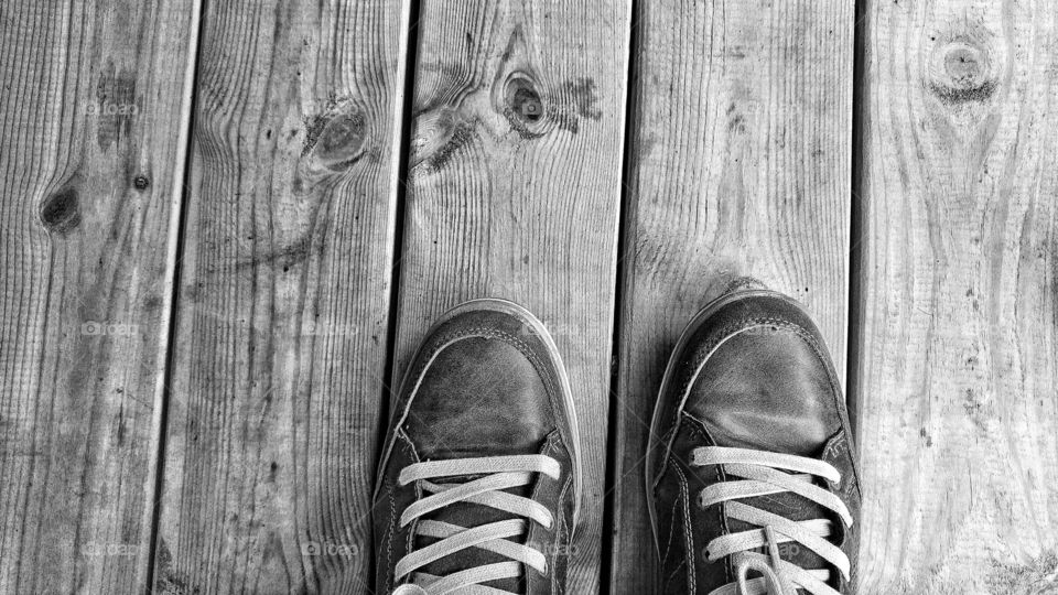 Feet on a wood floor.
