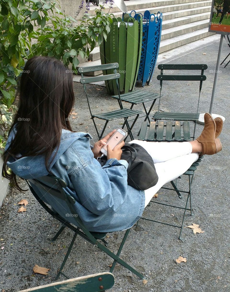 Girl Playing on Phone in Park NYC