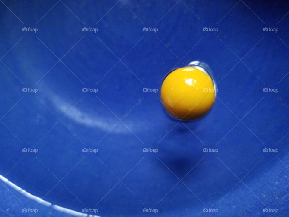 Liquids are cool...a yellow marble with a shadow under it seemingly floating in a bowl of water