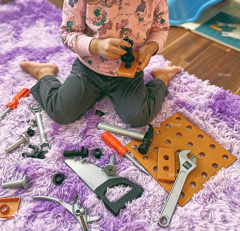 Toddler creating with play tools, toddler building indoors, toddler building with play tool set, toddler girl playing with tools, getting creative with toddlers, playing with toddler during the wintertime, being creative indoors