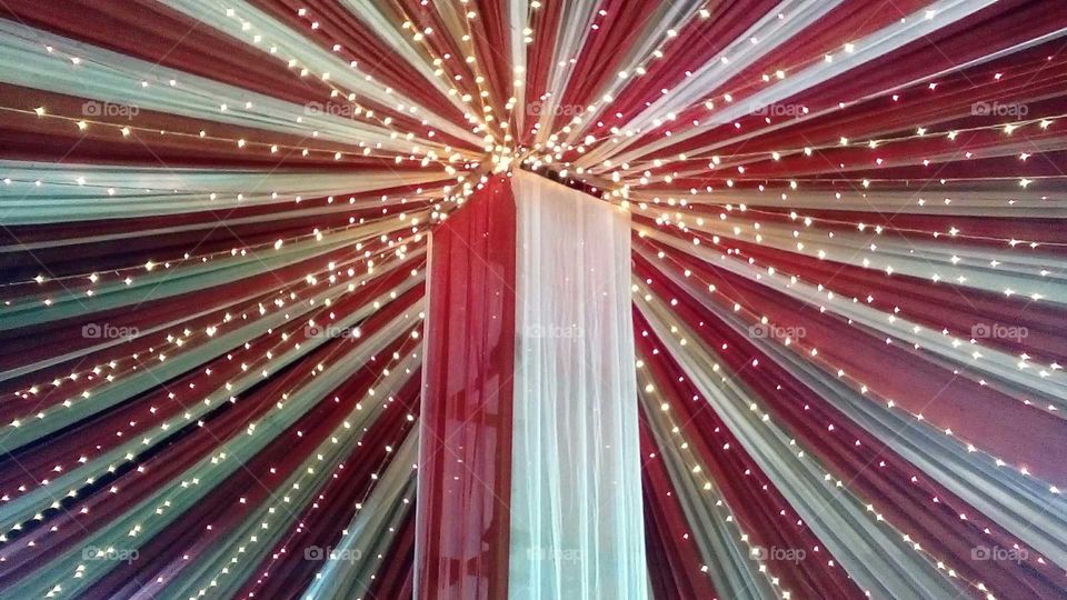 yellow lighting on white and red curtain an ceremony occasion