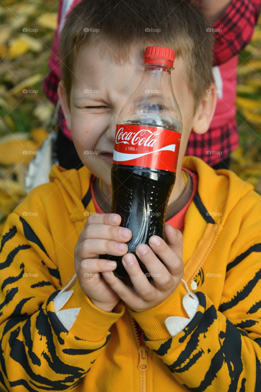 coca cola in the hands child drinking coca cola