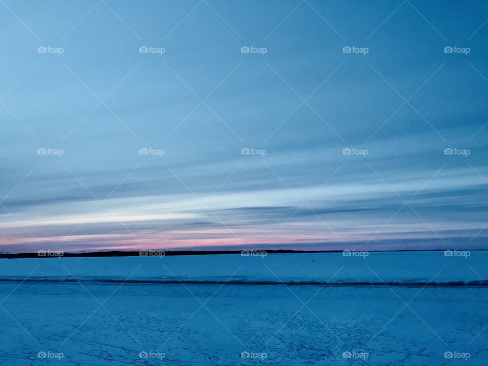 Sunset over the frozen lake