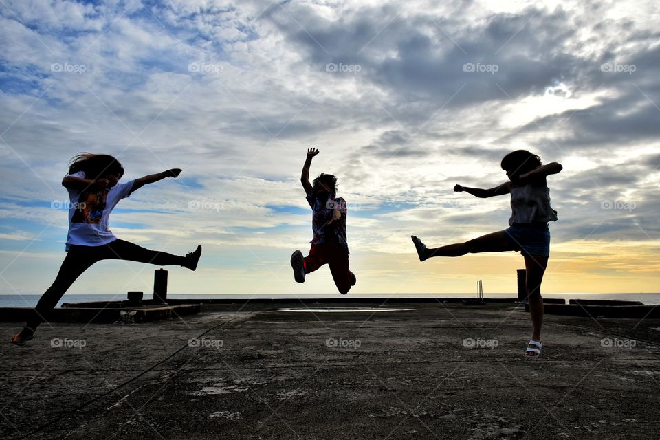 there jumping  at the beach