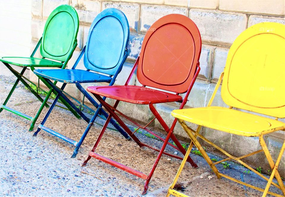 Colorful folding chairs in a row