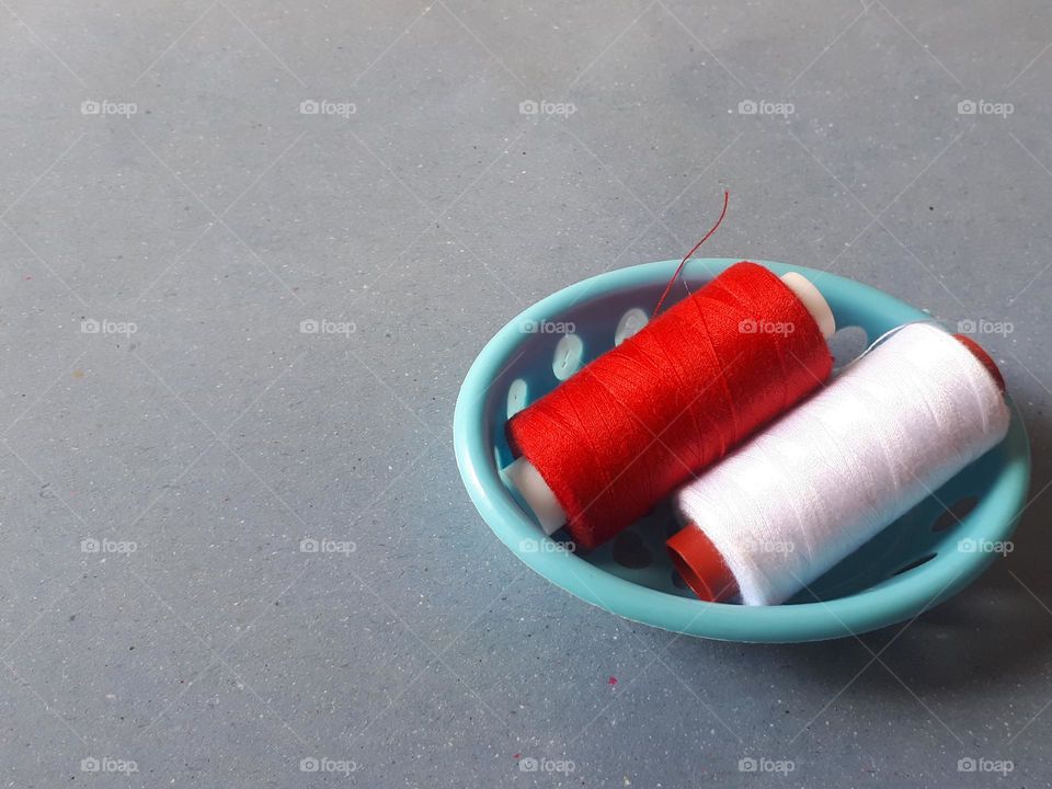 red and white threads in the basket