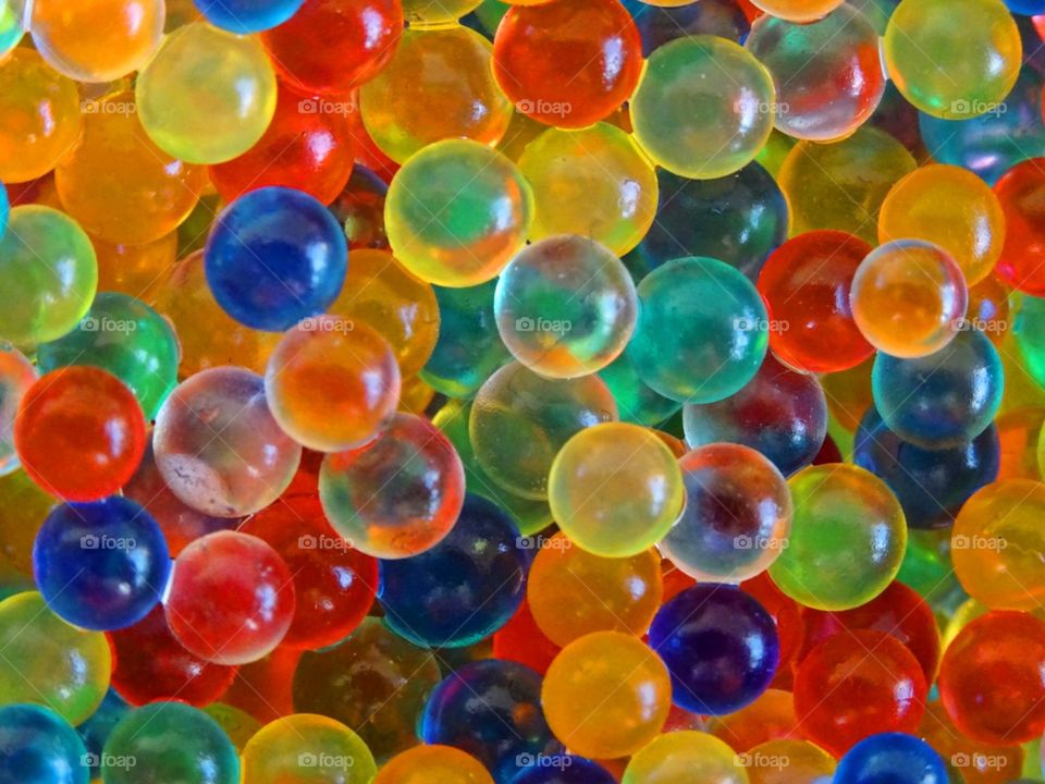closeup of small wet orbie balls of multiple colours