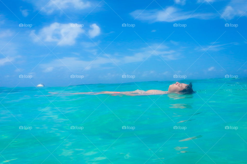 Boy floating in the Caribbean