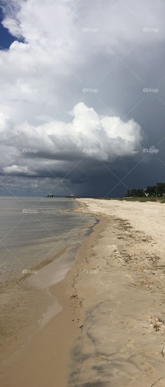 Dark sky storm approaches on Mississippi Gulf Coast beach.