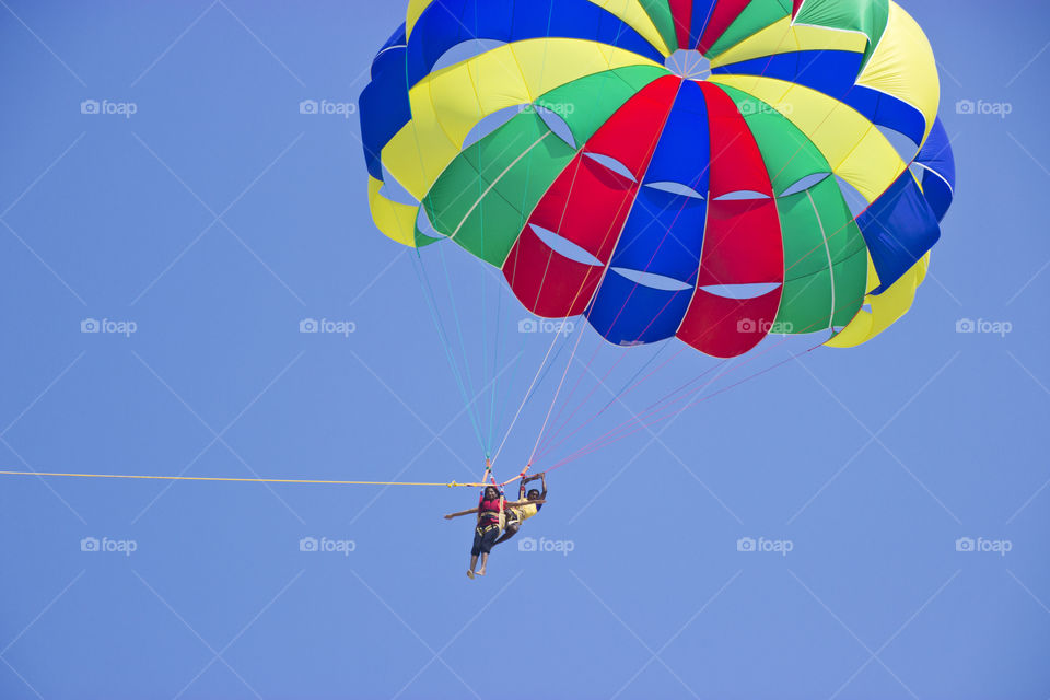 Having fun during adventurous parasailing on a sunny day