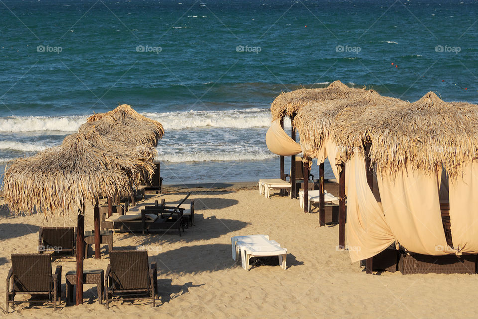 Beach umbrellas and sunbeds at beach in Bulgarian resort Pomorie