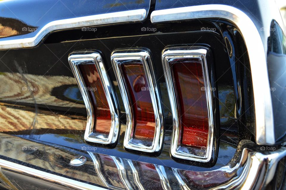 chic chrome parts of a retro car rear brakes framed by a chrome frame