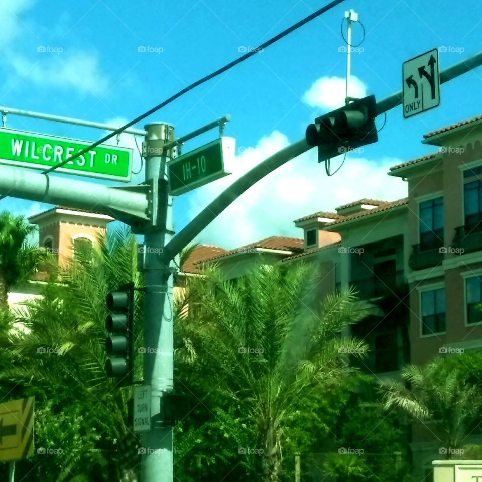 IH-10 at Wilcrest Dr Intersection traffic lights lush Palm Trees at the entrance of Resort Style Luxury Apartments