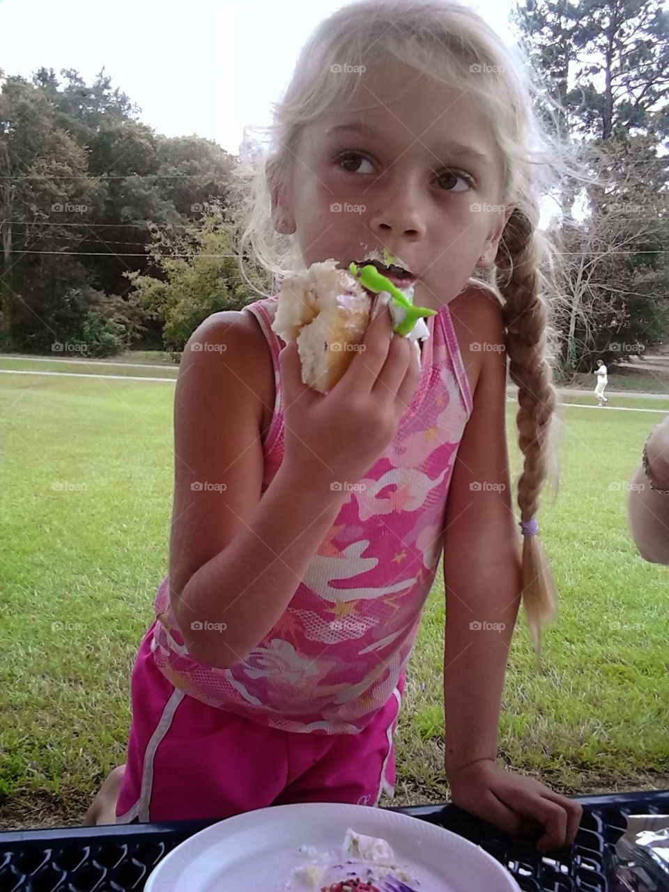Eating her cupcake
