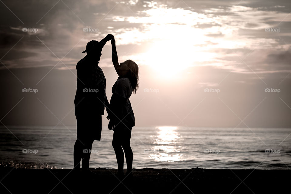 Couple dancing by the surf