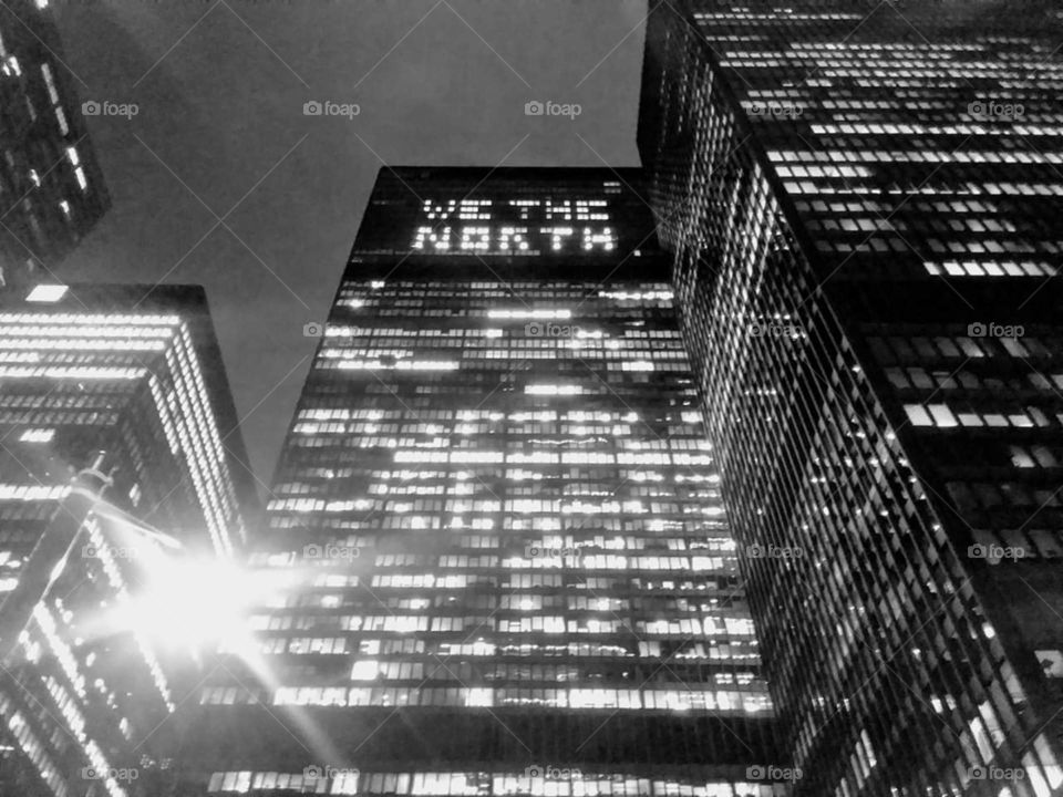"We the North" written in office lights, on a tall building after a Raptors game in Toronto.