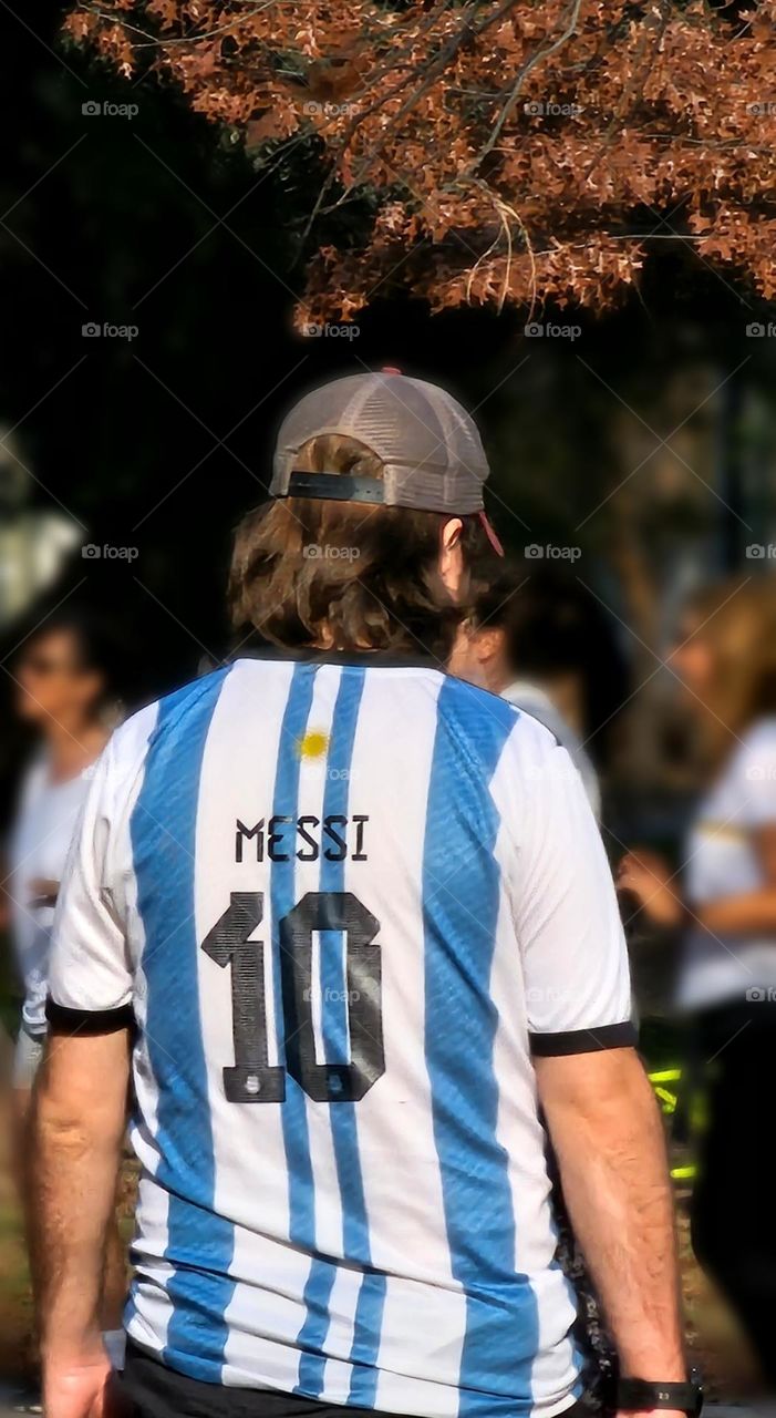 "Messi jersey" Young man wearing a #10 Messi Argentina jersey.  Background is blurred.