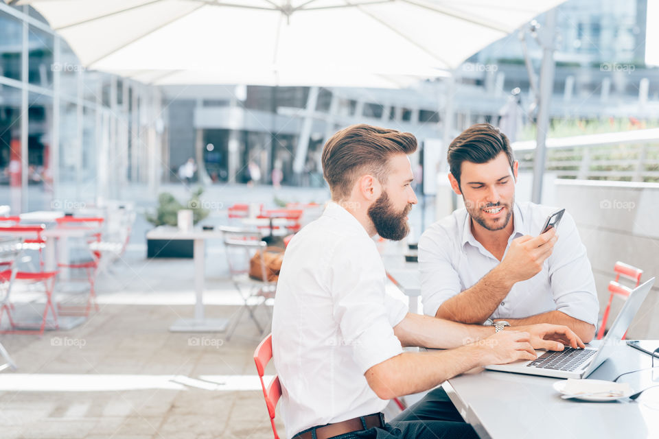 handsome bdarded business men working at the bar using smartphone and notebook - smartwoking, connection, business concept