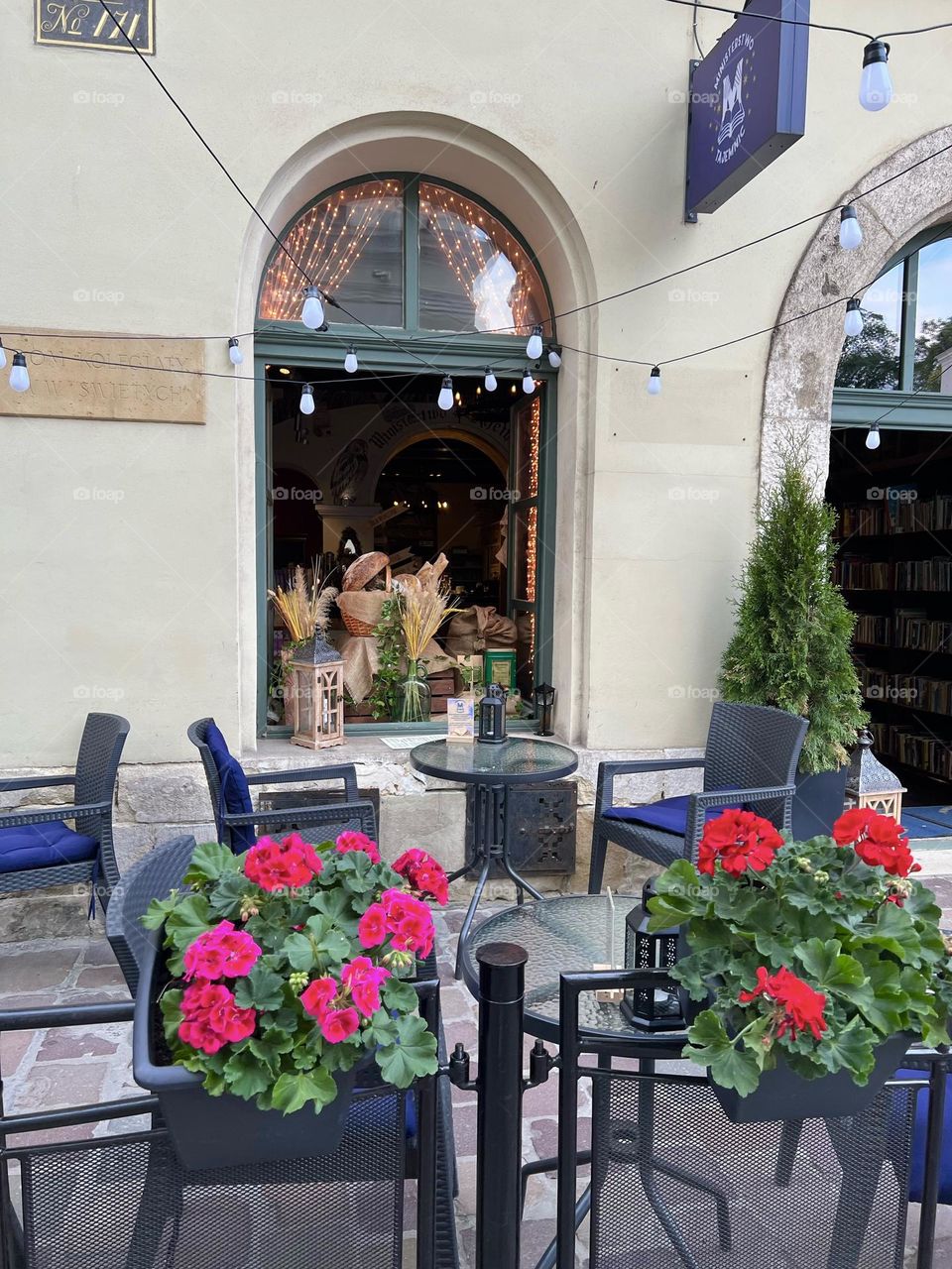 Tables in the cafe on the summer terrace are surrounded by flowers