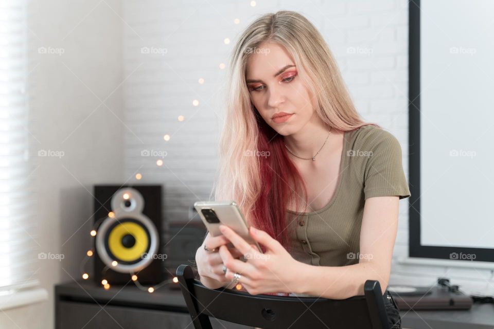 girl with long red hair using mobile phone