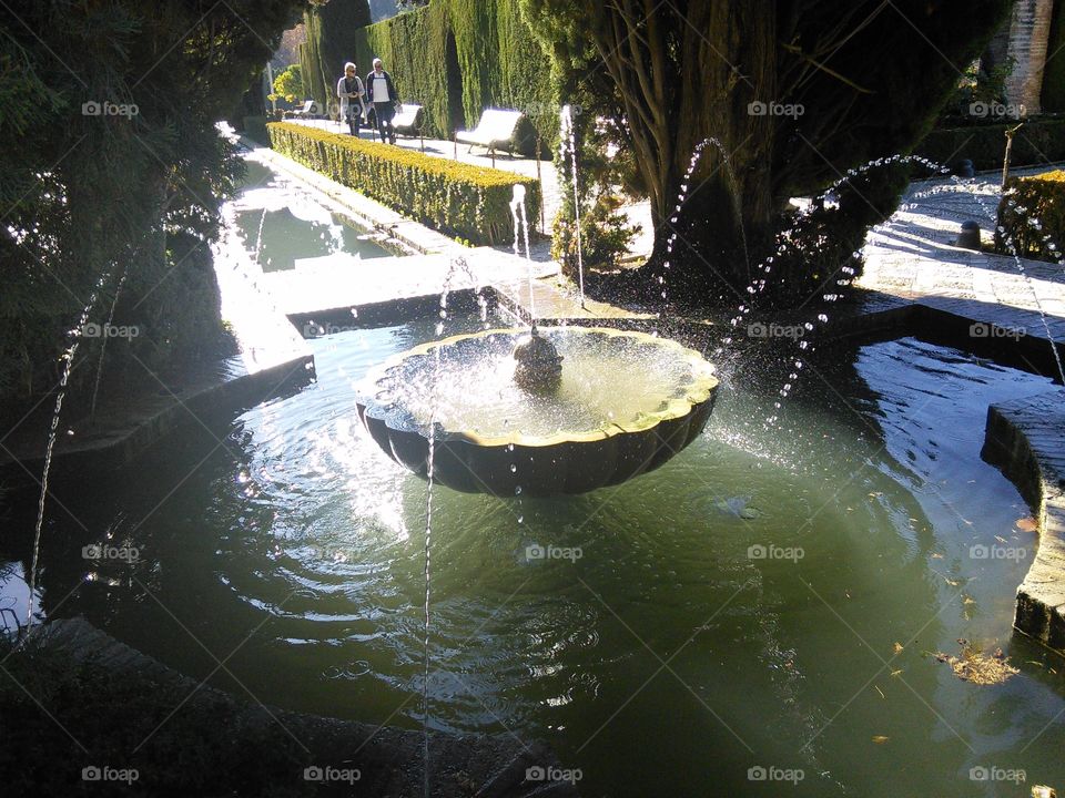 Fountain inside Generalife's gardens in morning light