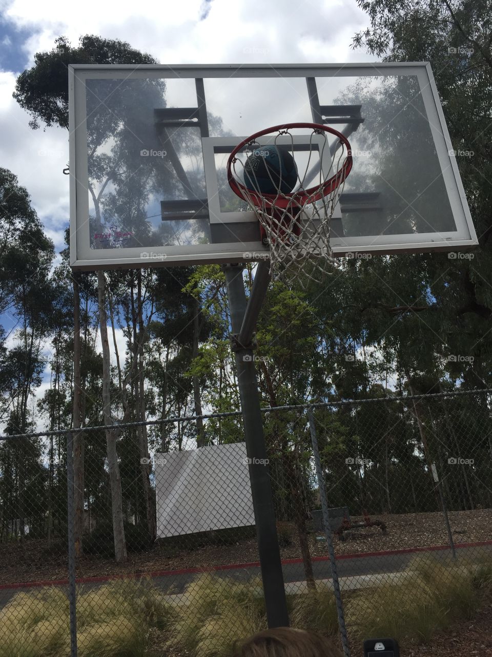Basketball stuck on hoop