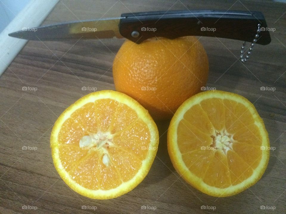 Slice of orange with knife