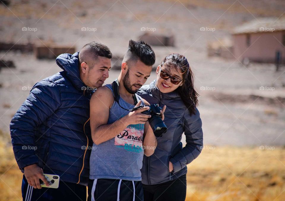 group of young people checking a camera