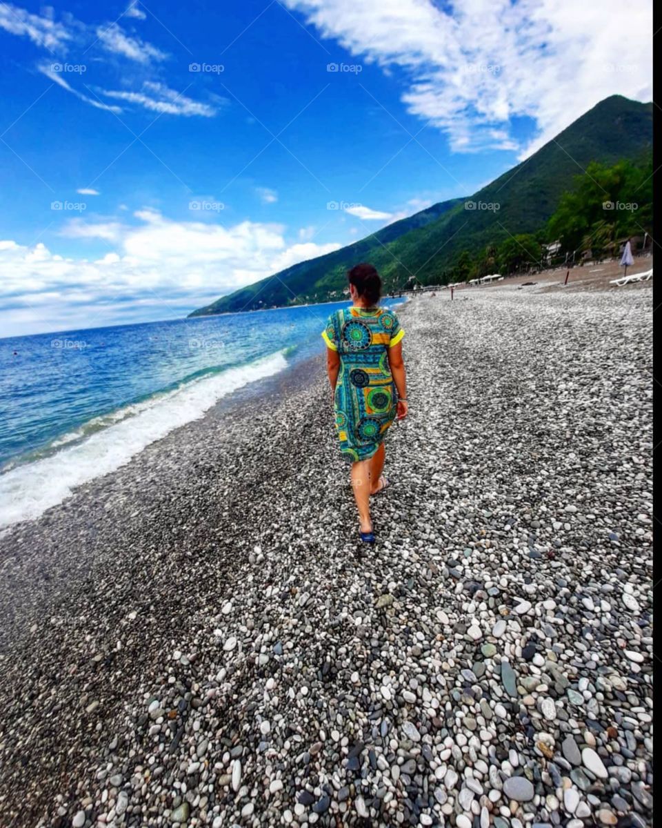 woman walking along the seashore