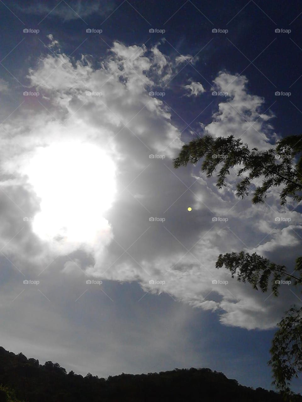 Nature in its glory, sun bursting through the cloud.