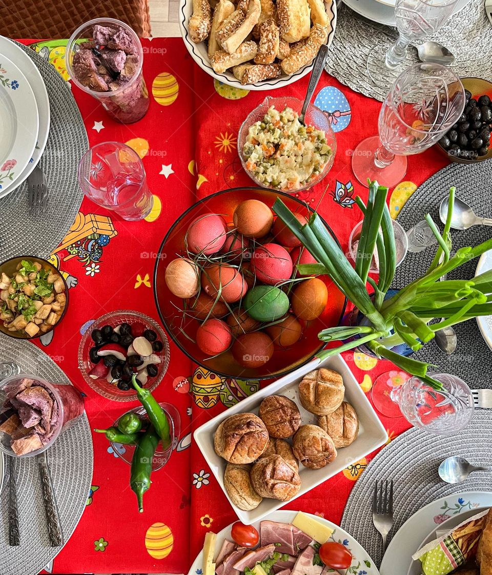 Easter food; traditional easter dyed eggs with bread and wine, salads, for the Easter lunch.