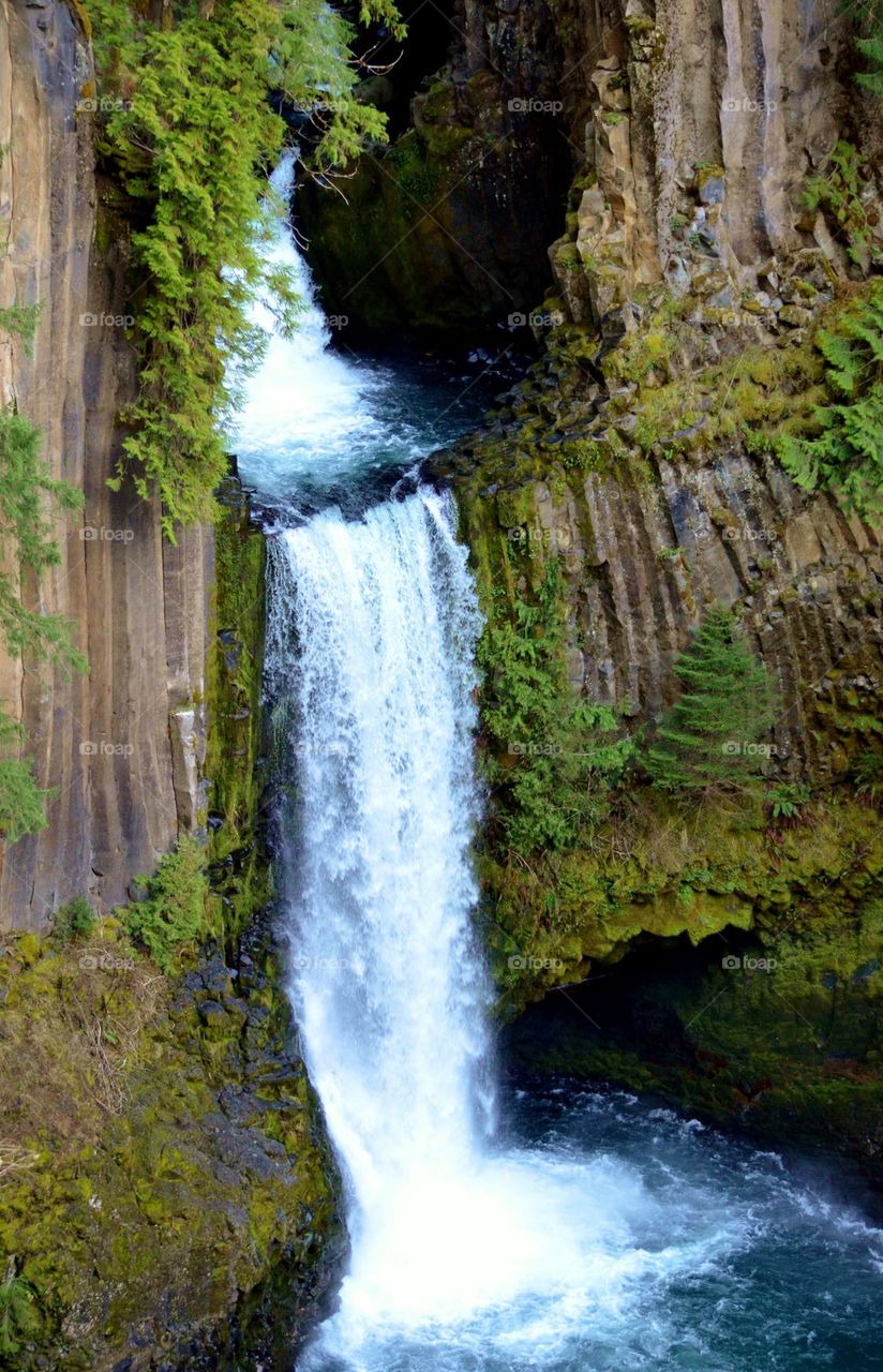 View of waterfall through rock