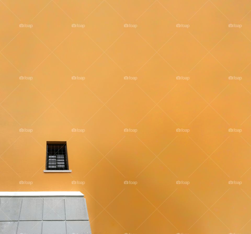 Minimalist yellow building with black windows