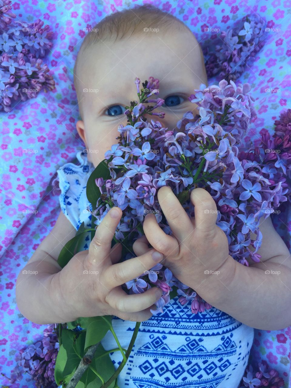 Baby girl holding flower bunch