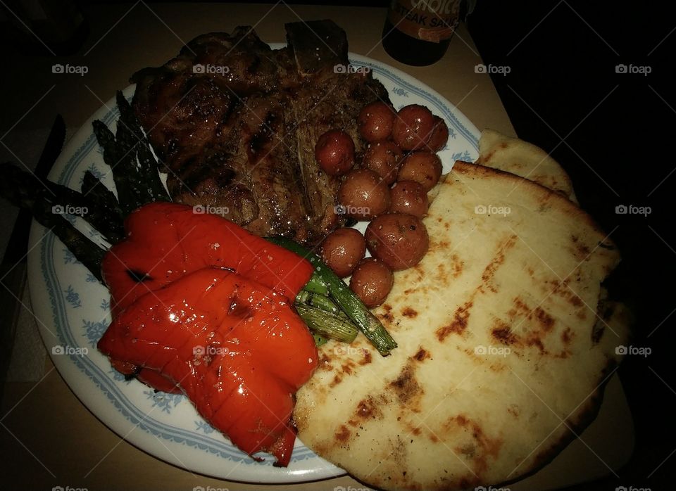 Grilled t-bone steak, grilled asparagus & sweet red peppers, rosemary roasted new potatoes, and grilled flat bread for dinner