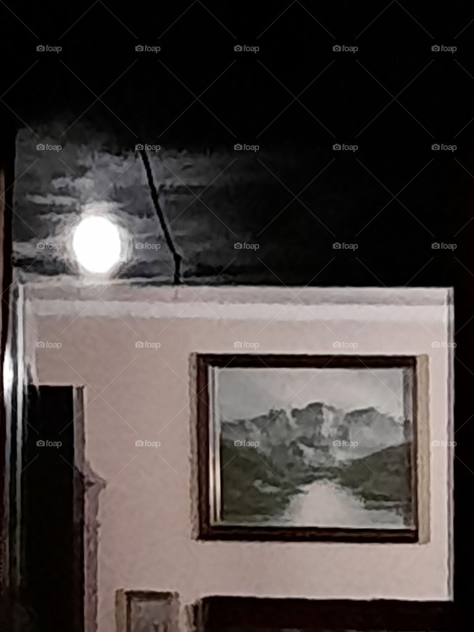 window view of full moon and reflection of the room